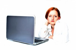 Unimpressed Red Head at Laptop New York Jobs PublicDomainPictures CC Zero